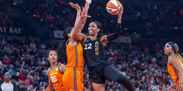Las Vegas Aces forward A'ja Wilson (22) posts up for a shot over Connecticut Sun center Brionna Jones during the first half in Game 1 of a WNBA basketball final playoff series Sunday, Sept. 11, 2022, in Las Vegas.