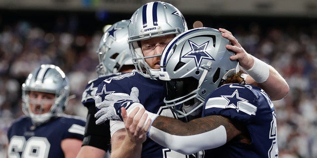 Dallas Cowboys running back Ezekiel Elliott, #21, celebrates with Dallas Cowboys quarterback Cooper Rush, #10, after scoring a touchdown against the New York Giants during the third quarter of an NFL football game, Monday, Sept. 26, 2022, in East Rutherford, New Jersey. 