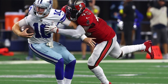 Devin White, #45 of the Tampa Bay Buccaneers, tackles Cooper Rush, #10 of the Dallas Cowboys, during the second half at AT& Stadium on Sept. 11, 2022 in Arlington, Texas. 