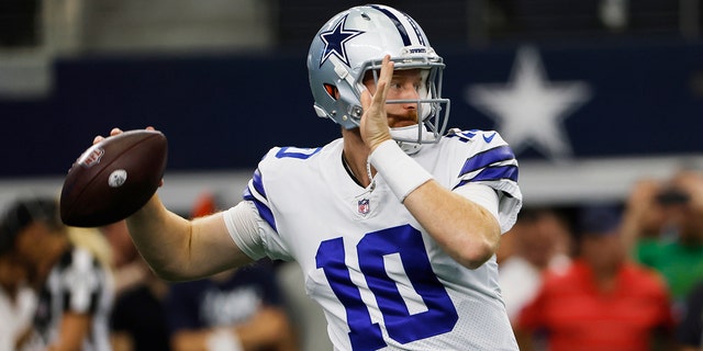 Dallas Cowboys quarterback Cooper Rush warms up before the game Sunday, Sept. 18, 2022, in Arlington, Texas.