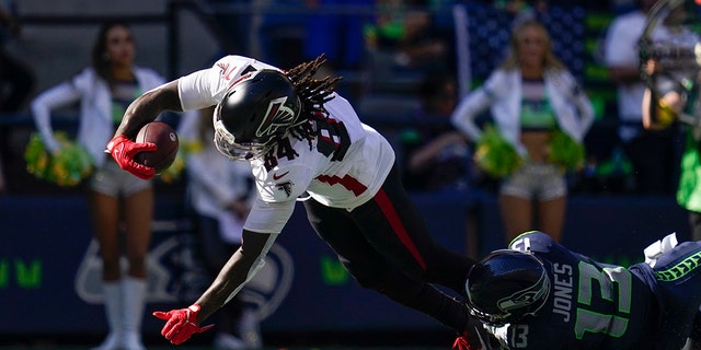 Atlanta Falcons running back Cordarrelle Patterson scores a touchdown as Seattle Seahawks safety Josh Jones defends during the first half of an NFL football game Sept. 25, 2022, in Seattle.