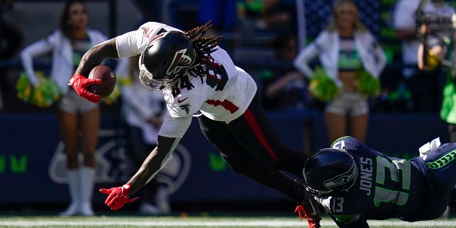 Atlanta Falcons running back Cordarrelle Patterson scores a touchdown as Seattle Seahawks safety Josh Jones defends during the first half of an NFL football game Sept. 25, 2022, in Seattle.