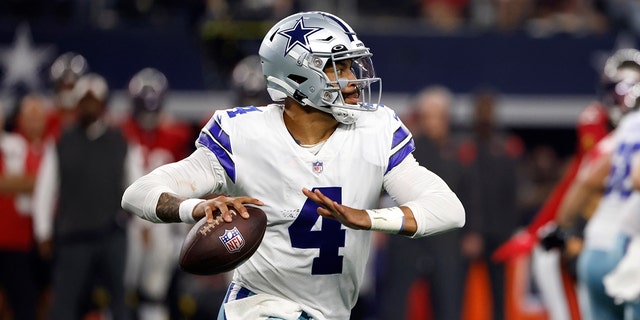 Dallas Cowboys quarterback Dak Prescott, 4, comes out of his pocket during the first half of an NFL football game against the Tampa Bay Buccaneers on Sept. 11, 2022 in Arlington, Texas. 