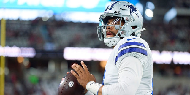 Dak Prescott of the Dallas Cowboys warms up before kickoff against the Tampa Bay Buccaneers on Sept. 11, 2022, in Arlington, Texas.