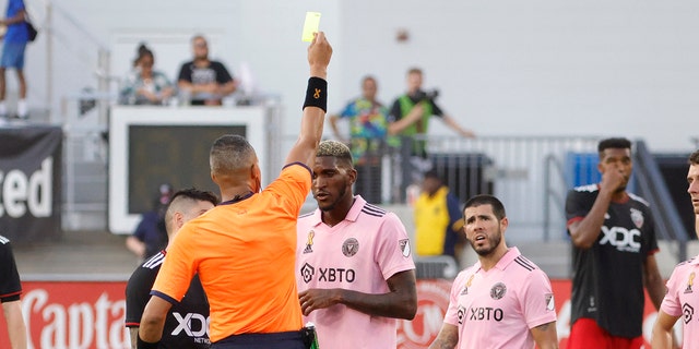 Referee Ismail Elfath (M) shows a yellow card to Inter Miami CF defender Damion Lowe, #31, and D.C. United forward Taxiarchis Fountas, #11, after an incident in the second half at Audi Field Sept. 18, 2022 in Washington, D.C. 