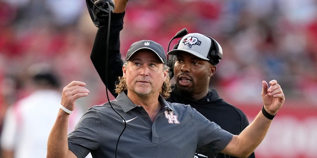 Cougars head coach Dana Holgorsen tosses his headset during the Kansas game, Saturday, Sept. 17, 2022, in Houston.