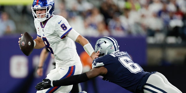 New York Giants quarterback Daniel Jones (8) tries to avoid a tackle from Dallas Cowboys safety Donovan Wilson during the second quarter on Sept. 26, 2022, in East Rutherford, New Jersey.