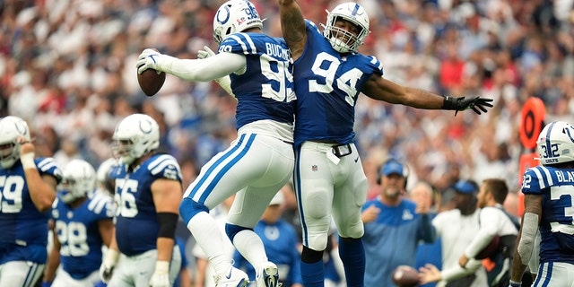 Indianapolis Colts defensive tackle DeForest Buckner, #99, celebrates with teammate defensive tackle Tyquan Lewis, #94, after recovering a fumble during the second half of an NFL football game Sunday, Sept. 11, 2022, in Houston. 