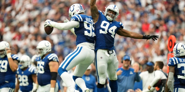 Indianapolis Colts defensive tackle DeForest Buckner, #99, celebrates with teammate defensive tackle Tyquan Lewis, #94, after recovering a fumble during the second half of an NFL football game Sunday, Sept. 11, 2022, in Houston.