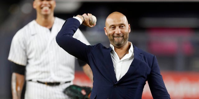 Baseball Hall of Famer Derek Jeter throws the ceremonial first pitch as Frankie Montas of the New York Yankees looks on before a game against the Tampa Bay Rays at Yankee Stadium Sept. 9, 2022, in the Bronx.