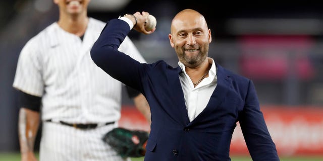 Baseball Hall of Famer Derek Jeter throws the ceremonial first pitch as Frankie Montas of the New York Yankees looks on before a game against the Tampa Bay Rays at Yankee Stadium Sept. 9, 2022, in the Bronx.