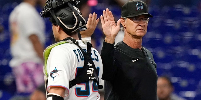 Marlins manager Don Mattingly wide receiver Nick Fortes during a doubleheader against the Texas Rangers, Monday, Sept. 12, 2022, in Miami.