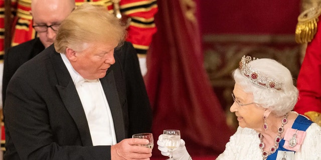 Britain's Queen Elizabeth II raises a glass with President Donald Trump during a state banquet in the ballroom at Buckingham Palace on June 3, 2019.