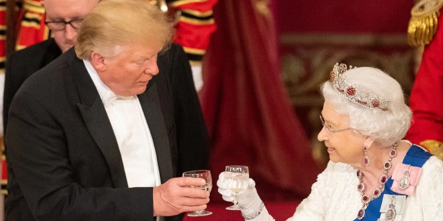 Britain's Queen Elizabeth II raises glasses with President Donald Trump at the state banquet in the Buckingham Palace Ballroom on June 3, 2019. 