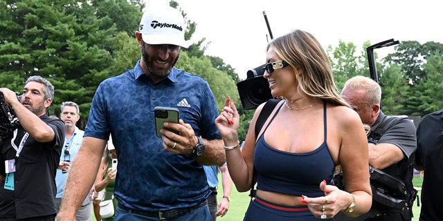 Dustin Johnson celebrates with his wife, Paulina Gretzky, after winning the LIV Golf Invitational - Boston at The Oaks Golf Course at The International on September 4, 2022, in Bolton, Massachusetts.