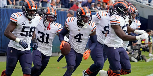 Chicago Bears safety Eddie Jackson (4) celebrates with teammates after intercepting a pass in the end zone against the Houston Texans during the first half of an NFL football game Sunday, Sept. 25, 2022, in Chicago.