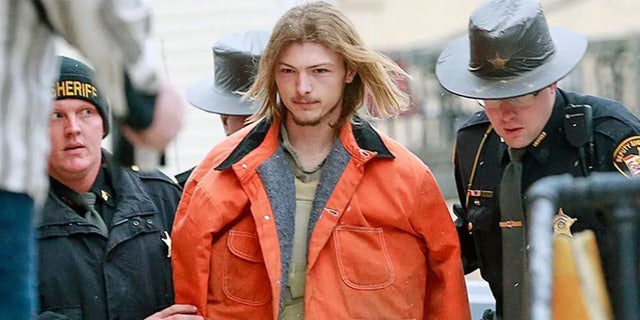 Edward "Jake" Wagner escorted by a police officer to Pike County Courthouse in Waverly, Ohio, in 2018.