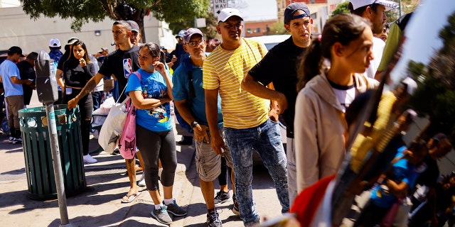 Migrants gather to receive donated clothes near a bus station after being released from U.S. Border Patrol custody in El Paso, Texas, U.S., Sept. 17, 2022.