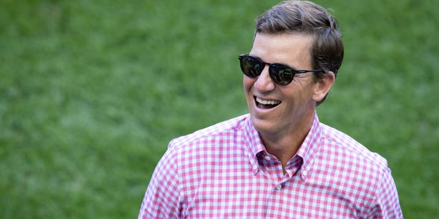 Former New York Giants quarterback Eli Manning, part of the NJ/NY Gotham FC ownership group, walks on the pitch before the match between Gotham FC and Angel City FC at Red Bull Arena in Harrison, New Jersey, on Aug. 28, 2022.