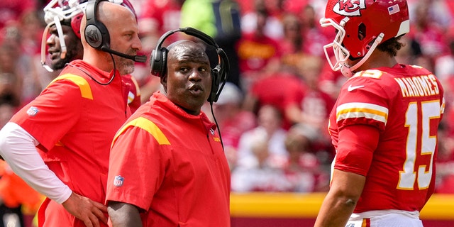 Kansas City Chiefs offensive coordinator Eric Bienemi reacts on headset conversation during the second quarter of the game against the Washington Commanders at Arrowhead Stadium on August 20, 2022 in Kansas City, Missouri.