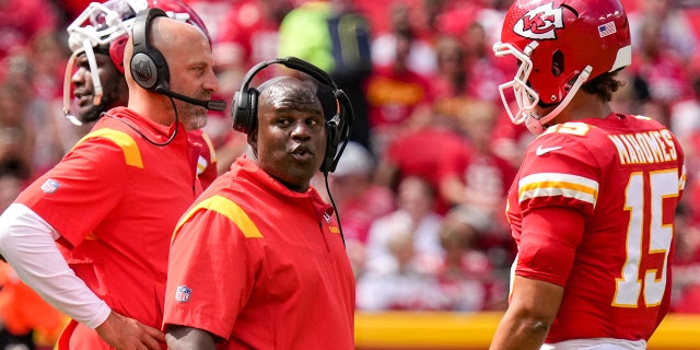 Kansas City Chiefs offensive coordinator Eric Bieniemy reacts to headset conversation during the second quarter of the game against the Washington Commanders at Arrowhead Stadium on August 20, 2022 in Kansas City, Missouri.