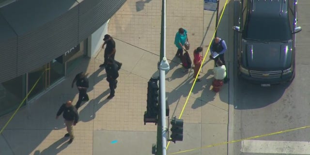 Investigators on the scene after an armed robbery outside an Apple store in Chicago.