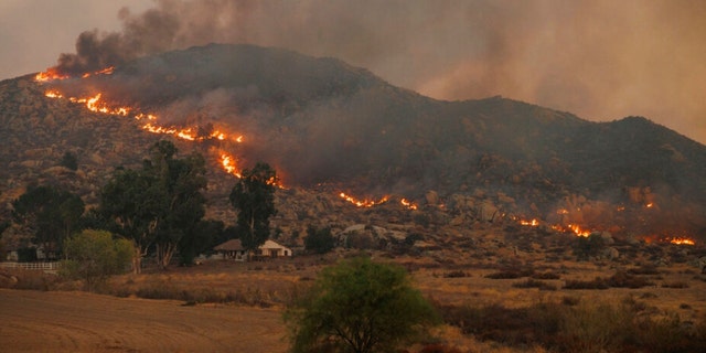 A hillside catches fire from the Fairview Fire Monday, Sept. 5, 2022, near Hemet, Calif. 