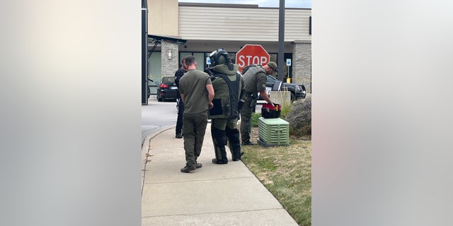 A police bomb technician at the scene where a pipe bomb was found behind a Safeway in Colorado.