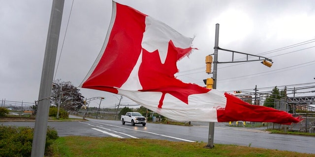 A Canadian flag waves in the high winds in Dartmouth, N.S. on Saturday, Sept. 24, 2022.