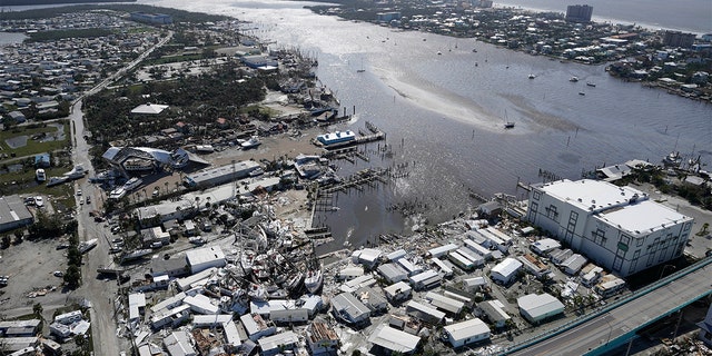 Damaged boats are strewn on the land and water in the aftermath of Hurricane Ian, Sept. 29, 2022, in Fort Myers, Florida.
