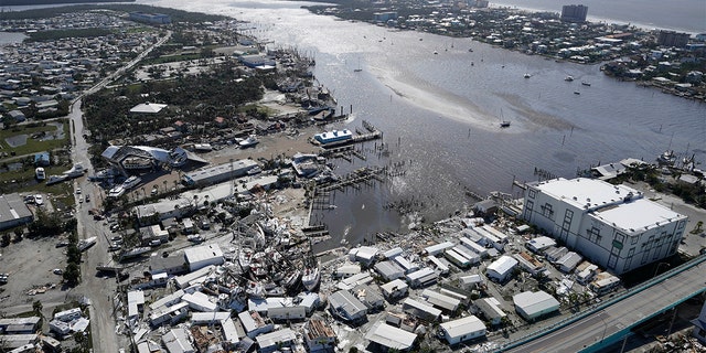 Damaged boats lie on the land and water in the aftermath of Hurricane Ian, Thursday, Sept. 29, 2022, in Fort Myers, Florida. 