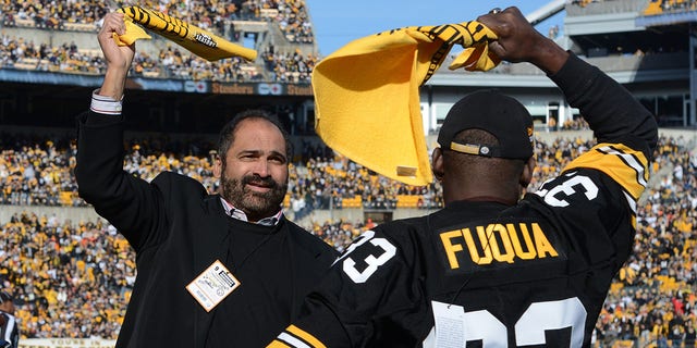 Franco Harris and John Fuqua shake the damn towel before the Steelers take on the Cincinnati Bengals at Heinz Field in Pittsburgh, Pennsylvania, Dec. 23, 2012. Former running his back was in attendance for Harris' 40th anniversary. "A blank reception."