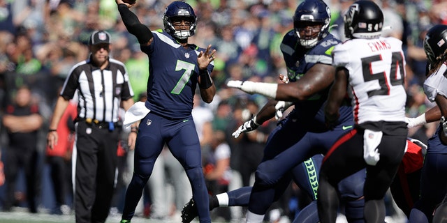 Seattle Seahawks quarterback Genno Smith throws a pass during the first half of an NFL football game against the Atlanta Falcons in Seattle on September 25, 2022. 