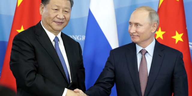 Russian President Vladimir Putin, right, shakes hands with Chinese President Xi Jinping during a signing ceremony following the Russian-Chinese talks on the sidelines of the Eastern Economic Forum in Vladivostok, Russia, on Sept. 11, 2018. (Sergei Chirikov / Pool / AFP via Getty Images)