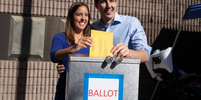 Democratic candidate for California's 10th congressional district Josh Harder and his wife Pam Harder place Pam's ballot in a ballot box at a polling station November 6, 2018 in Modesto, California.