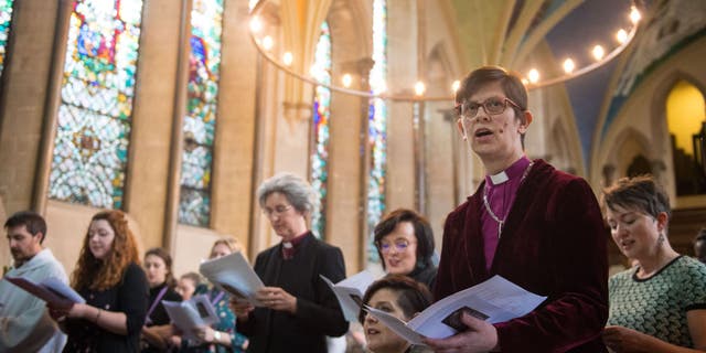 Bishop of Derby Right Rev. Libby Lane (at right, in foreground) sings at a service of celebration to mark the 25th anniversary of the ordination of women in the Church of England, at Lambeth Palace, London.