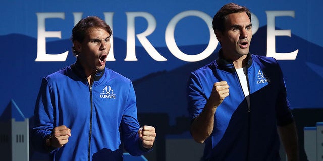 Rafael Nadal of Team Europe, left, and teammate Roger Federer celebrate during a singles match between Stefanos Tsitsipas of Team Europe and Taylor Fritz of Team World during the Laver Cup 2019 at Palexpo Sept. 20, 2019, in Geneva, Switzerland. 