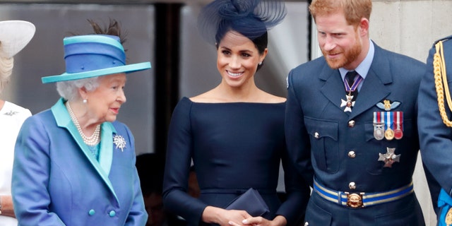 Queen Elizabeth II, pictured here with Meghan Markle and Prince Harry in the summer of 2018, was reportedly "exhausted" to decide what benefits would be taken away from his grandson and his wife due to their departure from the country and their resignation as members of the royal family.