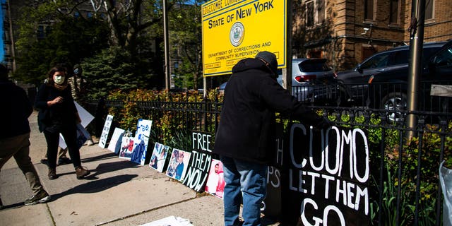 People organizes placards as they take part in a protest calling for the release of thousands of New Yorkers in state prisons outside of Edgecombe Correctional Facility on May 12, 2020, in New York City. Members of Center for Community Alternatives is asking for the release of thousands of New Yorkers in state prisons who are incarcerated because of technical parole violations or within one year of release.