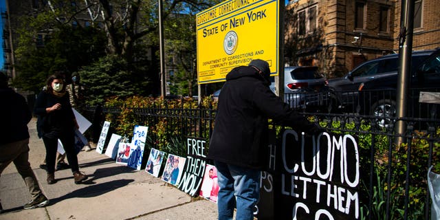 People organizes placards as they take part in a protest calling for the release of thousands of New Yorkers in state prisons outside of Edgecombe Correctional Facility on May 12, 2020, in New York City. Members of Center for Community Alternatives is asking for the release of thousands of New Yorkers in state prisons who are incarcerated because of technical parole violations or within one year of release.