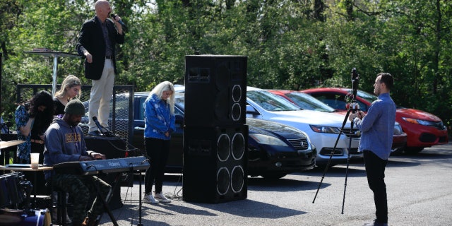 Pastor Chuck Salvo addresses the congregation during a drive-in service at On Fire Christian Church in Louisville, Kentucky on April 5, 2020.