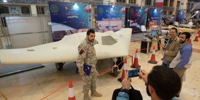 Members of Iran's Revolutionary Guards are pictured with a Shahed-171 (Simorgh) drone at the Defense Achievements Exhibition for the 40th Anniversary of the Islamic Revolution held at the Imam Khomeini Grand Mosque in central Tehran on the second day of the 10-day period. is taking  Celebration of the Islamic Revolution Day on February 2, 2019.  