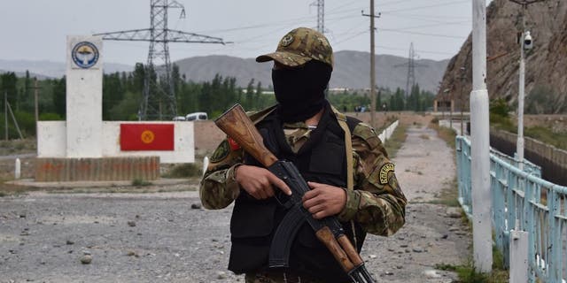 Kyrgyz soldiers stand guard "Golovnoy" Basin in May 2001.