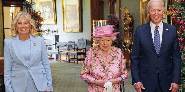 WINDSOR, ENGLAND - JUNE 13: Queen Elizabeth II with US President Joe Biden and First Lady Jill Biden in the Grand Corridor during their visit to Windsor Castle on June 13, 2021 in Windsor, England.