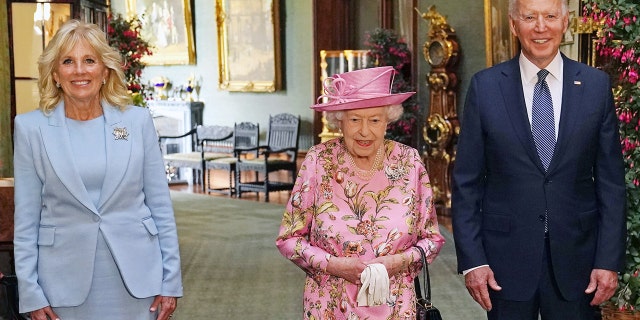 WINDSOR, ENGLAND - JUNE 13: Queen Elizabeth II with US President Joe Biden and First Lady Jill Biden in the Grand Corridor during their visit to Windsor Castle on June 13, 2021 in Windsor, England.