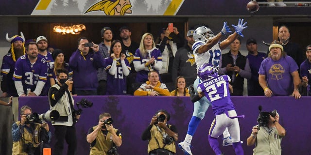 Dallas Cowboys wide receiver Amari Cooper catches the game-winning touchdown during the fourth quarter of a game against the Minnesota Vikings at U.S. Bank Stadium in Minneapolis, Minnesota, on Oct. 31, 2021.