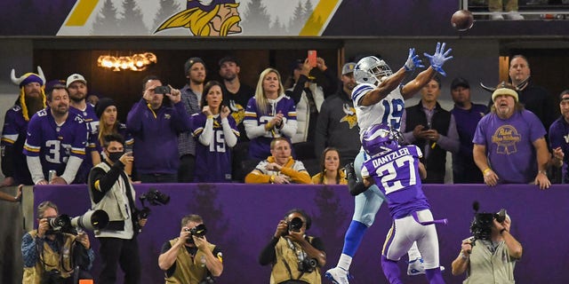 Dallas Cowboys wide receiver Amari Cooper catches the game-winning touchdown during the fourth quarter of a game against the Minnesota Vikings at U.S. Bank Stadium in Minneapolis, Minnesota, on Oct. 31, 2021.