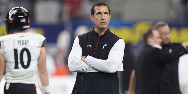 Cincinnati coach Luke Fickell watches his team warm up before the Goodyear Cotton Bowl game between the Bearcats and the Alabama Crimson Tide in AT and T Stadium in Arlington, Texas, on Dec. 31, 2021.