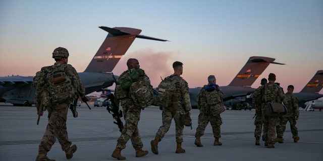 Soldiers of the 82nd Airborne Division walk to board a plane from Pope Army Airfield in Fort Bragg, North Carolina on February 14, 2021, as they are deployed to Europe as the crisis between Russia and Ukraine escalates. 