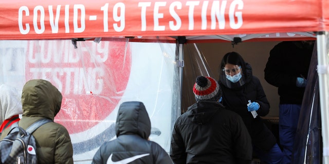 People line up to receive COVID-19 tests on Times Square on Feb. 14, 2022.